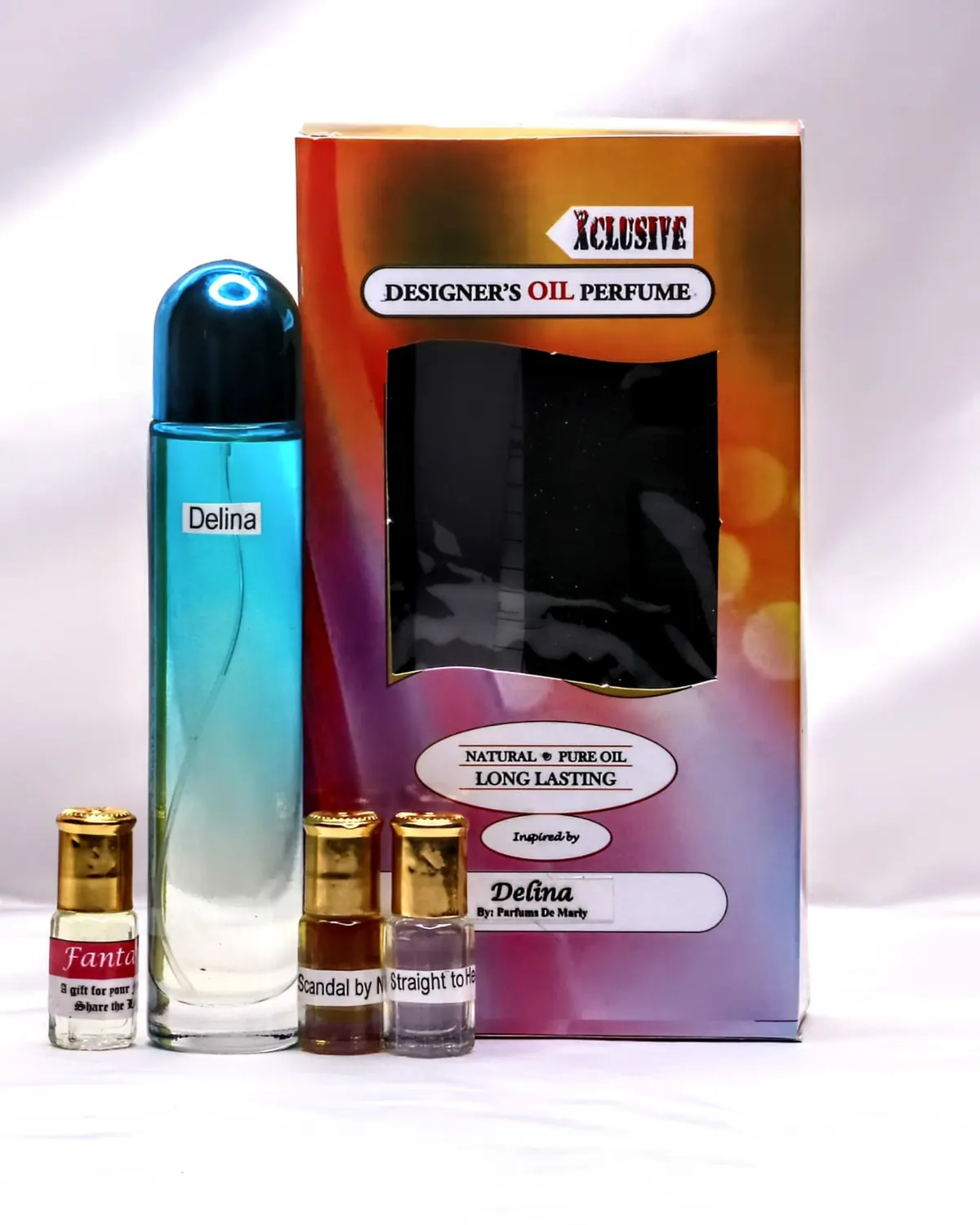 A large blue bottle of perfume oil standing beside its printed Xclusive box