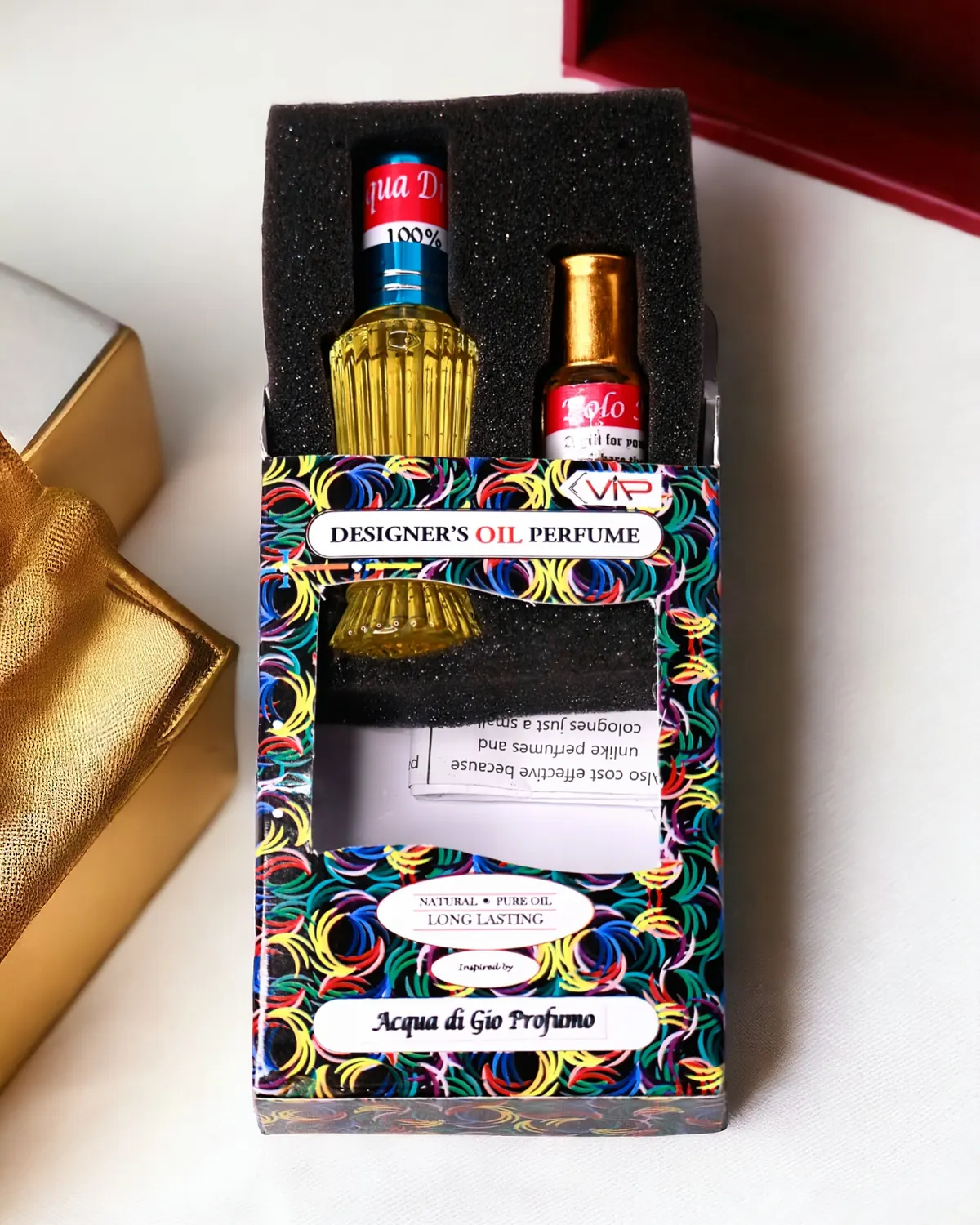 A ribbed glass bottle of perfume oil seated in a foam tray inside an open printed box