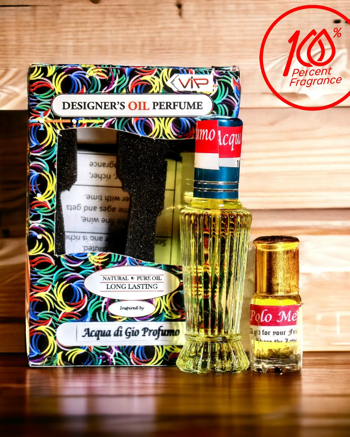A ribbed glass bottle of perfume oil and a small vial in front of the printed VIP box