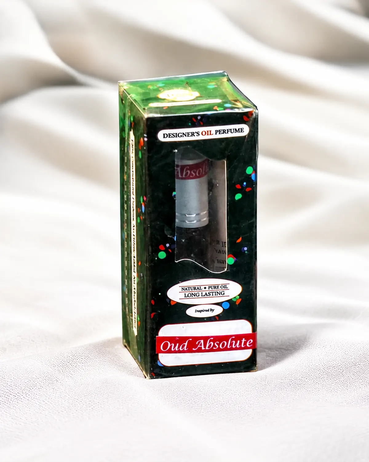 A printed green Designer's Oil Perfume box with the roller bottle visible through its window