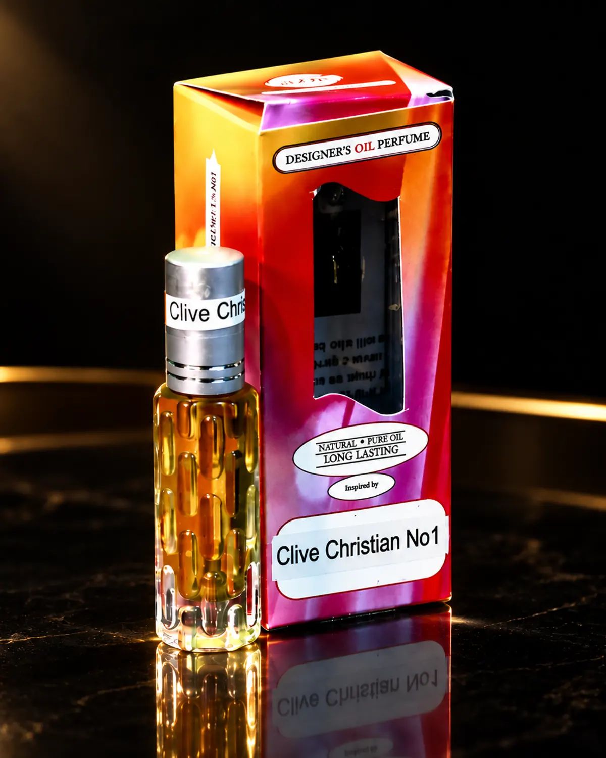 A 10 ml roller bottle of perfume oil and its box on a dark marble surface
